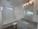 Bathroom featuring granite vanity, soaking tub with tile surround, and neutral finishes at 22023 E 38Th Pl, Aurora, CO 80019