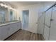 Bright bathroom featuring dual sinks, granite countertop and a sleek glass enclosed shower at 22023 E 38Th Pl, Aurora, CO 80019