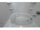 Close-up of a clean, white bathtub with tiled walls and chrome fixtures at 22023 E 38Th Pl, Aurora, CO 80019