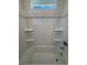 White bathtub with tiled surround and built-in shelves for storage at 22023 E 38Th Pl, Aurora, CO 80019