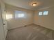 Light-filled bedroom featuring neutral carpet, recessed lights, and bright windows at 22023 E 38Th Pl, Aurora, CO 80019