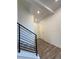 Bright entryway with wood-look flooring, staircase, and modern black metal handrail at 22023 E 38Th Pl, Aurora, CO 80019