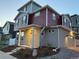 Inviting two-story home with red siding, gray stucco, covered porch, and neat front yard at 22023 E 38Th Pl, Aurora, CO 80019