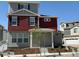 Two-story home showcasing red siding, gray stucco, dark shutters, and a cozy covered entry at 22023 E 38Th Pl, Aurora, CO 80019