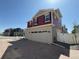 Attractive home with a two-car garage, red siding, gray stucco, and well-maintained landscaping at 22023 E 38Th Pl, Aurora, CO 80019