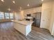 Bright, modern kitchen features a large center island with granite countertops and stainless steel appliances at 22023 E 38Th Pl, Aurora, CO 80019