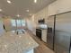 Modern kitchen featuring a spacious island with granite countertops and stainless steel appliances at 22023 E 38Th Pl, Aurora, CO 80019