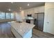 Kitchen with large island, stainless steel appliances, granite countertops and bright living space at 22023 E 38Th Pl, Aurora, CO 80019