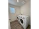 Well-lit laundry room featuring modern washer and dryer and window at 22023 E 38Th Pl, Aurora, CO 80019