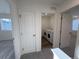 Hallway view of laundry room with modern washer and dryer, with white trim and neutral paint at 22023 E 38Th Pl, Aurora, CO 80019