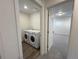 Convenient laundry room featuring modern, front-loading washer and dryer units at 22023 E 38Th Pl, Aurora, CO 80019