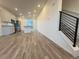 Open-concept living space with a modern kitchen, staircase with railings, and light wood flooring at 22023 E 38Th Pl, Aurora, CO 80019