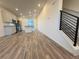 Open-concept layout with wood flooring, connecting the kitchen, living area, and staircase at 22023 E 38Th Pl, Aurora, CO 80019