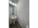 Clean powder room featuring pedestal sink, large mirror, and modern lighting at 22023 E 38Th Pl, Aurora, CO 80019