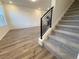 Entryway to carpeted stairs and wood-look flooring leads to the living area at 22023 E 38Th Pl, Aurora, CO 80019