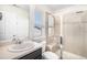 This contemporary bathroom has a glass door shower, a light-colored vanity with a window, and great natural light at 5929 Echo Hollow St, Castle Rock, CO 80104
