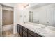 This well-lit bathroom features a double sink vanity and tiled floor, along with a bathtub-shower combo at 5929 Echo Hollow St, Castle Rock, CO 80104