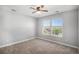 This bedroom features neutral paint, carpet, and a ceiling fan, complete with a window that brings in natural light at 5929 Echo Hollow St, Castle Rock, CO 80104