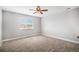 This bedroom features neutral paint, carpet, and a ceiling fan, complete with a window that brings in natural light at 5929 Echo Hollow St, Castle Rock, CO 80104