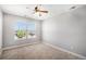 This cozy bedroom features neutral paint, carpet, and a ceiling fan, complete with a window that brings in natural light at 5929 Echo Hollow St, Castle Rock, CO 80104