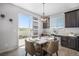 Bright breakfast nook featuring stylish light fixture and sliding glass doors to the outside at 5929 Echo Hollow St, Castle Rock, CO 80104