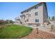 Back exterior showing second story deck and stairs, fenced yard with garden plots at 5929 Echo Hollow St, Castle Rock, CO 80104