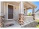Inviting front porch with stacked stone columns and a classic wooden door at 5929 Echo Hollow St, Castle Rock, CO 80104