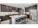 Gorgeous kitchen with stainless steel appliances, a large island with seating, and dark wood cabinetry at 5929 Echo Hollow St, Castle Rock, CO 80104