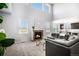 Sun-lit living room with fireplace, large windows, and views into the kitchen at 5929 Echo Hollow St, Castle Rock, CO 80104