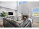 Bright living room features a cozy fireplace, large windows, and modern decor at 5929 Echo Hollow St, Castle Rock, CO 80104