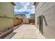 Narrow backyard showcasing a shed, a brick-lined patio, and the home's exterior with a screened door at 4081 Odessa St, Denver, CO 80249