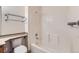 Bright bathroom showcasing a shower-tub combo with tile surround, along with a sleek towel rack at 4081 Odessa St, Denver, CO 80249