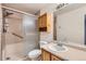 Bathroom features a shower with sliding glass door, oak cabinets, and a large vanity mirror at 4081 Odessa St, Denver, CO 80249