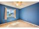 Cozy bedroom featuring blue walls, neutral carpet, and a ceiling fan, illuminated by natural light at 4081 Odessa St, Denver, CO 80249