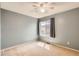 This carpeted bedroom features a ceiling fan and large window at 4081 Odessa St, Denver, CO 80249