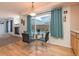 Dining area featuring a glass table with seating and natural light from a large window at 4081 Odessa St, Denver, CO 80249