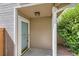 Inviting front entrance featuring neutral siding, a light fixture, and a storm door at 4081 Odessa St, Denver, CO 80249