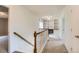 Bright hallway featuring white shelving with built-in cabinets and wood railing on the staircase at 4081 Odessa St, Denver, CO 80249