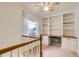 Well-lit hallway featuring built-in shelving with a desk area, complemented by natural light from the window at 4081 Odessa St, Denver, CO 80249