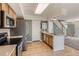The kitchen features stainless steel appliances, hardwood floors, and a white countertop island at 4081 Odessa St, Denver, CO 80249