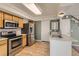 Open kitchen showcases stainless steel appliances, hardwood flooring, and a sink with white countertop at 4081 Odessa St, Denver, CO 80249