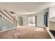 Spacious living room featuring an open layout, neutral carpet, and plenty of natural light at 4081 Odessa St, Denver, CO 80249