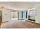 Spacious carpeted living room with natural light and an opening leading to the kitchen at 4081 Odessa St, Denver, CO 80249