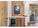 Convenient bar area features custom wood work, a framed art piece and access to the back patio at 8278 Raphael Ln, Littleton, CO 80125