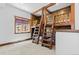 Fun bedroom offers custom built-in bunkbeds with wooden ladder and an inviting window view at 8278 Raphael Ln, Littleton, CO 80125