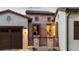 Close exterior shot of the front stone entryway with decorative railing, lamps and potted plants at 8278 Raphael Ln, Littleton, CO 80125