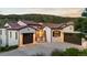 Front exterior of home with a brick-stone entryway and a three-car garage with stone accents at 8278 Raphael Ln, Littleton, CO 80125