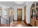 Inviting foyer with hardwood floors, staircase, and natural light at 8278 Raphael Ln, Littleton, CO 80125