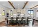 Gourmet kitchen with a large island, breakfast bar, custom cabinetry, stainless steel appliances, and modern lighting at 8278 Raphael Ln, Littleton, CO 80125