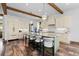 Gourmet kitchen features a large island with seating, custom cabinetry, stainless steel appliances, and wood beam ceiling at 8278 Raphael Ln, Littleton, CO 80125